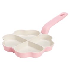 a pink and white tray with three compartments on it, one has a spoon in the middle