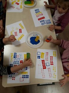 children playing with matching numbers on paper plates