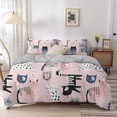 a bed with pink and black cats on it