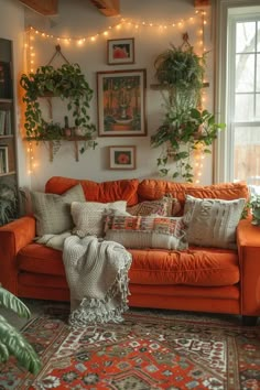 a living room with an orange couch and potted plants