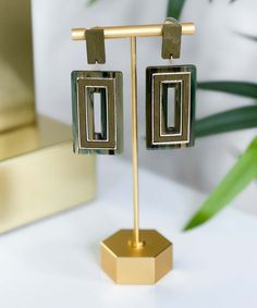 Introducing our "Squared Away Wood & Acetate Rectangle Earrings - Olive," a stylish and unique addition to your jewelry collection. These elegant earrings feature a perfect combination of wood and acetate in a chic rectangle shape, showcasing a beautiful olive color. The post back ensures a secure and comfortable fit, while the dangle style adds movement and flair to these exquisite earrings.
Crafted with care and attention to detail, these earrings have a length of 2.5 inches, making them a Rectangle Earrings, Wood Post, Olive Color, Elegant Earrings, Rectangle Shape, Geometric Design, Attention To Detail, Nature Inspiration, Color Pop