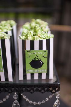 small black and white striped bags filled with green popcorn