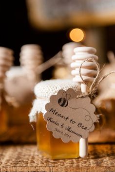 honey jars with labels on them sitting on a table