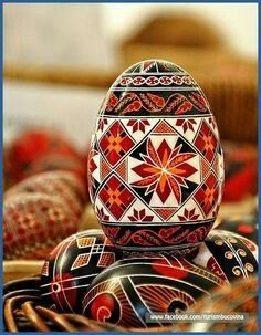 an egg sitting on top of a basket next to other decorative items in the background