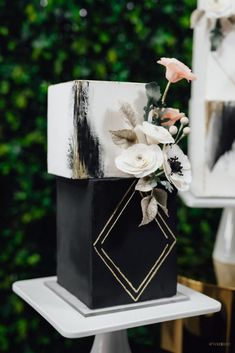 a black and white cake with flowers on top