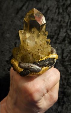 What a stunning piece of finger candy: I set a rare and scarce Smoky Citrine Record Keeper Quartz Tower into hand sculpted material, painted it, microglittered it and sealed it with a high gloss glaze. I attached a high quality, antique bronze adjustable mount to it which is wide, comfortable, secure and will adjust to fit most if not all. The ring measures 2.5" x 2" with a height of 3". A true showstopper from the Atelier of Kat Kouture! Rocker Chic Accessories, Smoky Citrine, Sculpting Materials, Unique Pendant Necklace, Statement Bib Necklace, The Atelier, Crystal Tower, Chest Piece, Elephant Head