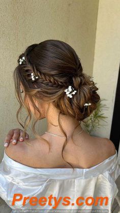 a woman wearing a wedding dress with flowers in her hair