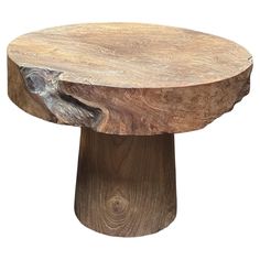 a wooden table with an animal head carved into it's center piece, on a white background