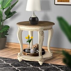 a table with a lamp on it next to a potted plant in a living room