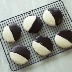 chocolate covered donuts with white frosting on a cooling rack