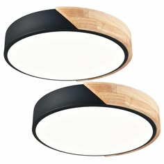 two black and white ceiling lights with wood accents on the top, one light is dim