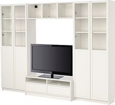 a white entertainment center with shelves and a flat screen tv