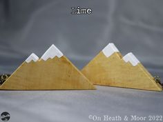 two wooden mountains are shown with the words time on them