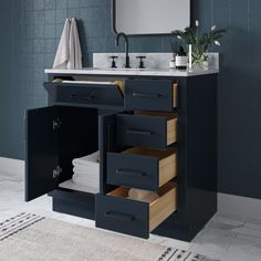 a bathroom vanity with drawers and a mirror on the wall next to it is shown