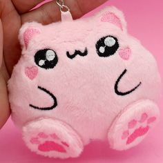 Description:   The Kawaii Plush Kitty keychain is the perfect way to accessorize your key ring and show your love for all things kawaii! This soft, plush kitty has bright eyes and a cheerful smile. The keychain measures 3 inches tall and is made of high quality materials. This soft plush keychain comes complete with a metal ring and clip, making it easy to attach to your keys, backpack, or purse. This keychain is the perfect way to add a touch of kawaii fun to your everyday. The cute kitty is made from soft plush fabric. The kawaii clothing on this plush cat keychain is inspired by the popular Harajuku fashion style, she is super soft and makes a great companion for on-the-go. Whether you're a lover of all things kawaii or just need a new keychain, this charming plushie is sure to please. Harajuku Accessories, Cat Kawaii, Plushie Keychain Decira, Mode Harajuku, Kawaii Pink Plush Bag, Kawaii Key Rings, Cat Plush Keychain, Kawaii Keychain Mymelody, Stocking Stuffers For Girls