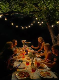 a group of people sitting around a table eating food