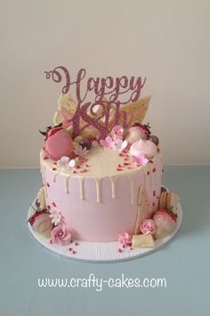 a birthday cake with pink frosting and decorations