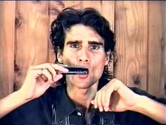 a man is brushing his teeth with an electric toothbrush in front of him and wood planks behind him