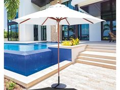 an umbrella sitting next to a swimming pool