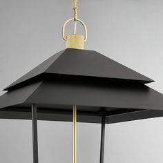 a black and gold light hanging from a ceiling