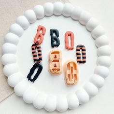 the letters are made out of plastic and placed on a white plate with black handles