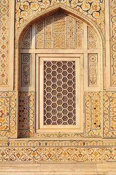 an intricately designed window in the middle of a building