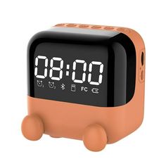 an orange alarm clock sitting on top of a table