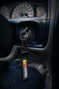 the interior of a car with a key chain hanging from it's center console