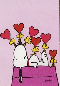 a snoopy dog with hearts on his head is sitting in a box and looking at the ground