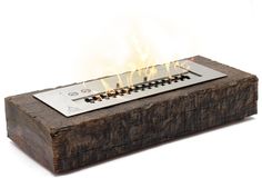 a fire pit made out of wood with flames coming out of the top and sides