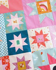 a colorful patchwork quilt with many different designs on the top and bottom pieces, including stars