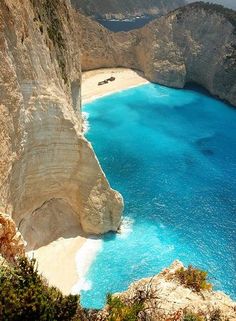 the water is blue and clear at this beach in the mountains near an area with white sand