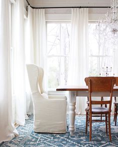 a dining room with a chandelier hanging from the ceiling