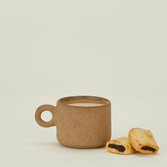 a cup of coffee next to some cookies