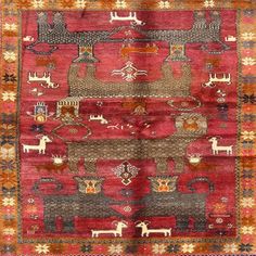 an old rug with animals and other things on it's side, in red tones