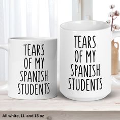 two white coffee mugs with words that read tears of my spanish students and tears of my spanish students