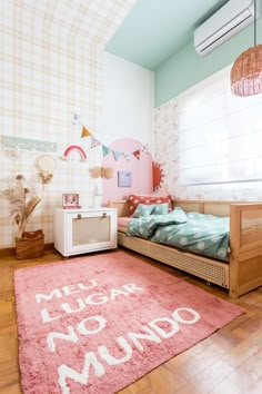 a bedroom with a pink rug and wooden floors