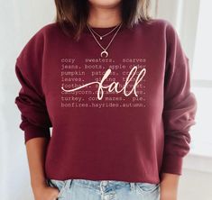 Fall with words sweatshirt.   Available in variety of colors, sizes and lettering colors.   Sweatshirt shown in listing photos is Maroon, with cream and white lettering (scroll through photos to see each color).  Ash sweatshirt is shown with Brown, Maroon and Black Lettering. Gildan Brand sweatshirt is Unisex (Men's fit) so it runs on the larger side for women-Please see size chart.   Adult shirts only available in this style.   Shirt Colors may vary slightly - depending on your screen. If shirt color or size that you order is unavailable-I will message you to select another color.  If we cannot come up with a solution, I will refund you. (Please keep mind that the black vinyl will not show up well on some dark shirt colors, the white shows up well on most colors.)  To Order: 1. Choose Swe Sweatshirt Ideas, Orange Sweatshirt, Fall Words, Fall Orange, Fall Stuff, Create Shirts, Adulting Shirts, Fall Sweatshirt, Branded Sweatshirts