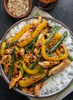 a bowl filled with chicken, peppers and rice