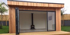 a wooden shed with sliding glass doors on the outside