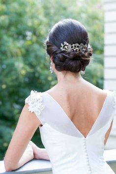 the back of a woman's head wearing a white dress and a tiara