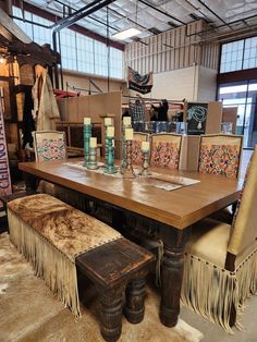 a large wooden table surrounded by chairs and rugs