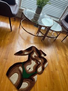 a living room with wooden floors and a rug that looks like a monkey on the floor