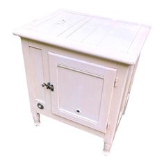 a small white cabinet with two doors on one side and an open drawer on the other