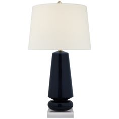 a black table lamp with a white shade