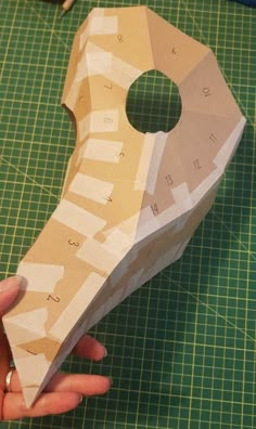 someone is making a paper model that looks like a rocket ship with numbers on it