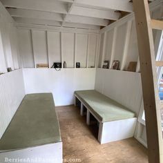 an empty room with two benches in the corner and one bench on the other side