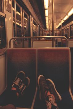 a person's feet are sitting on the seat of a subway train, with a quote written in spanish above them