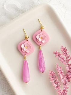 Say hello to Aurora, a classic Disney Princess from the movie Sleeping Beauty! Drop Length: 2.4 in. Colors: Pink florals with yellow center on Pink Background Earring Hardware: 18k Gold-Plated ball posts and pink tear drop beads Care instructions Please note that Wild Honey Clay earrings are handcrafted with polymer clay and must be handled with delicate care.Do not bend the earrings. Store them in their box when traveling to ensure protection & do not keep them in direct sunlight.Return PolicyW Barbie Inspired Polymer Clay Earrings, Disney Themed Clay Earrings, Cute Pink Polymer Clay Earrings, Disney Princess Polymer Clay Earrings, Whimsical Pink Polymer Clay Earrings, Disney Princess Earrings, Pink Charm, Wild Honey, Drop Beads