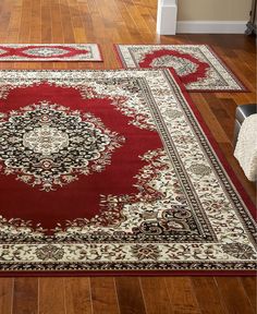 three rugs on the floor in a room with hardwood floors and hard wood floors